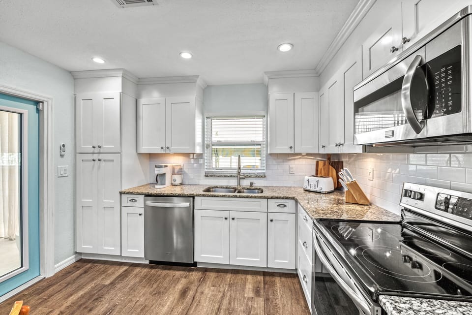 Prep fresh seafood or local produce in a modern, fully stocked kitchen designed for ease and style.
