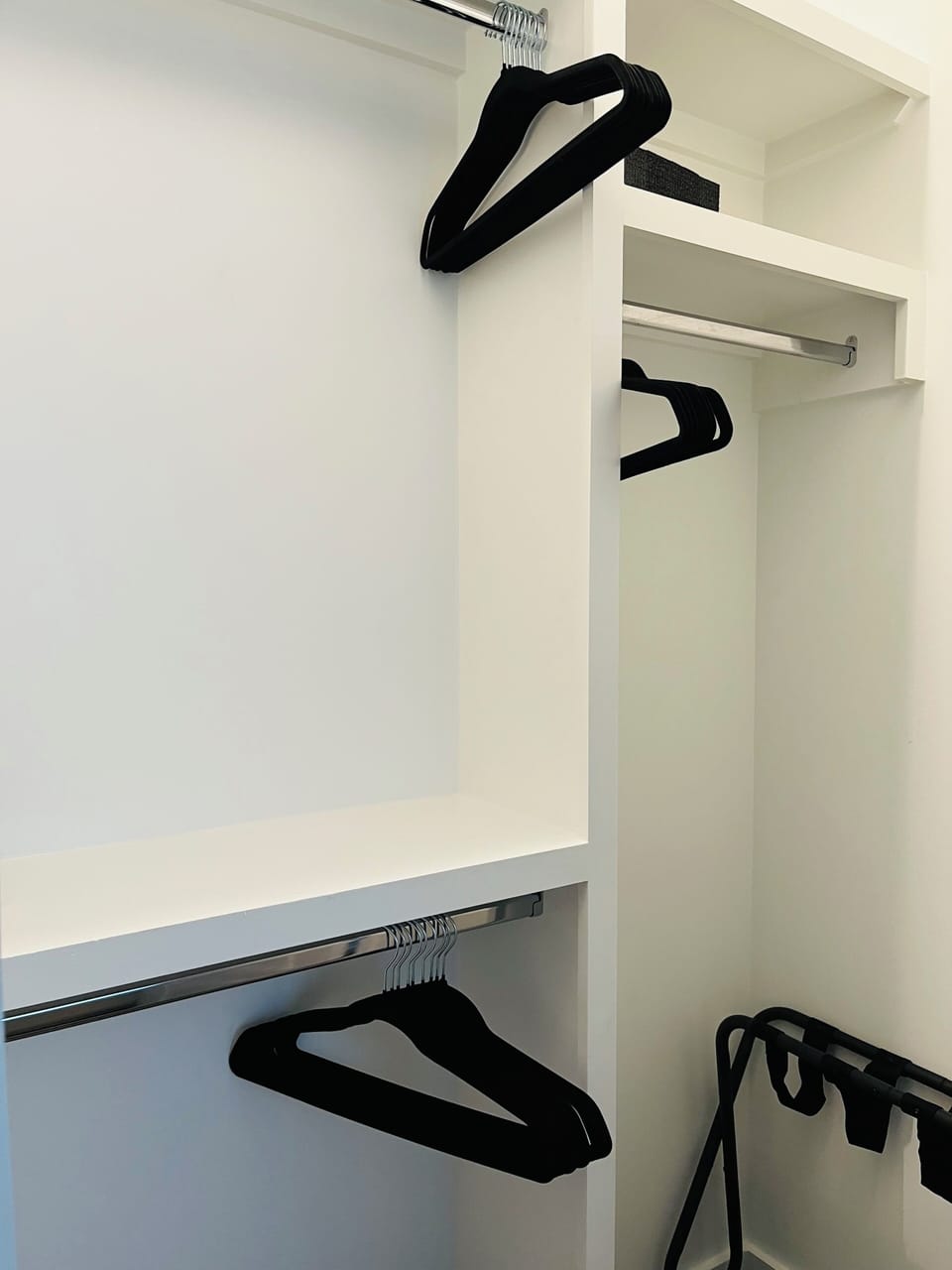 Each bedroom has a closet with hangers and a luggage rack