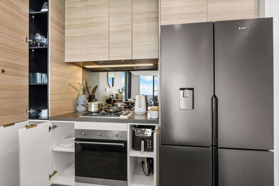 Cook with ease in a modern kitchen complete with gas cooktop, oven, air fryer, and quality cookware provided.