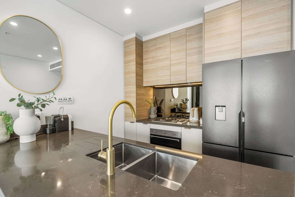 Fully equipped designer kitchen featuring premium appliances, Samsung fridge, Smeg cooking appliances, and everything needed for longer stays.