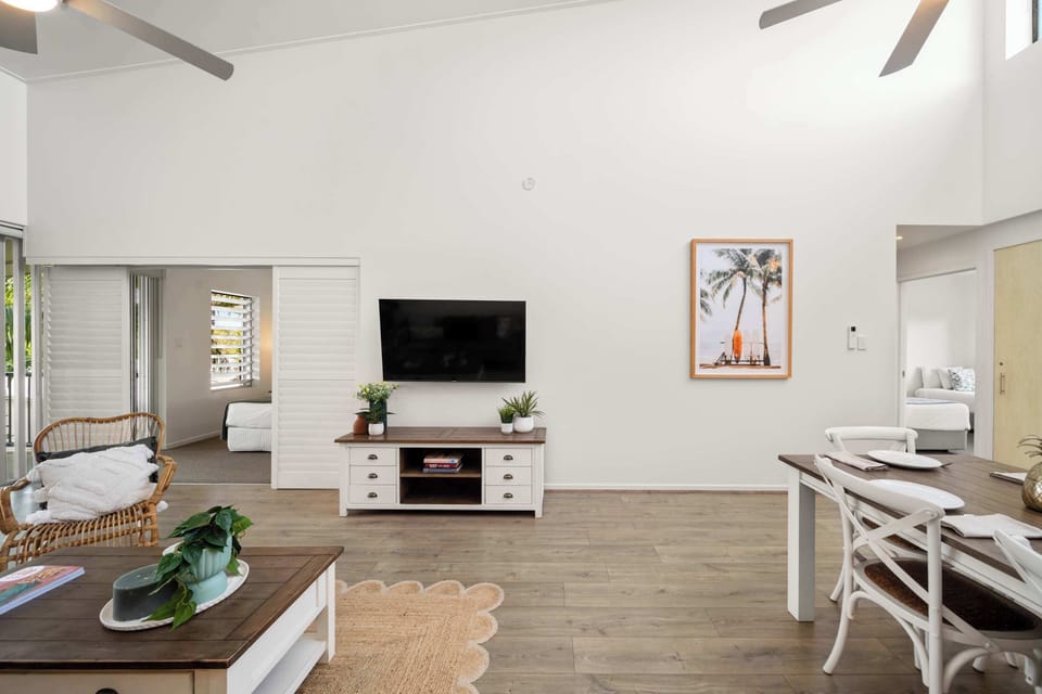 Inviting living space with soaring ceilings and plantation louvres