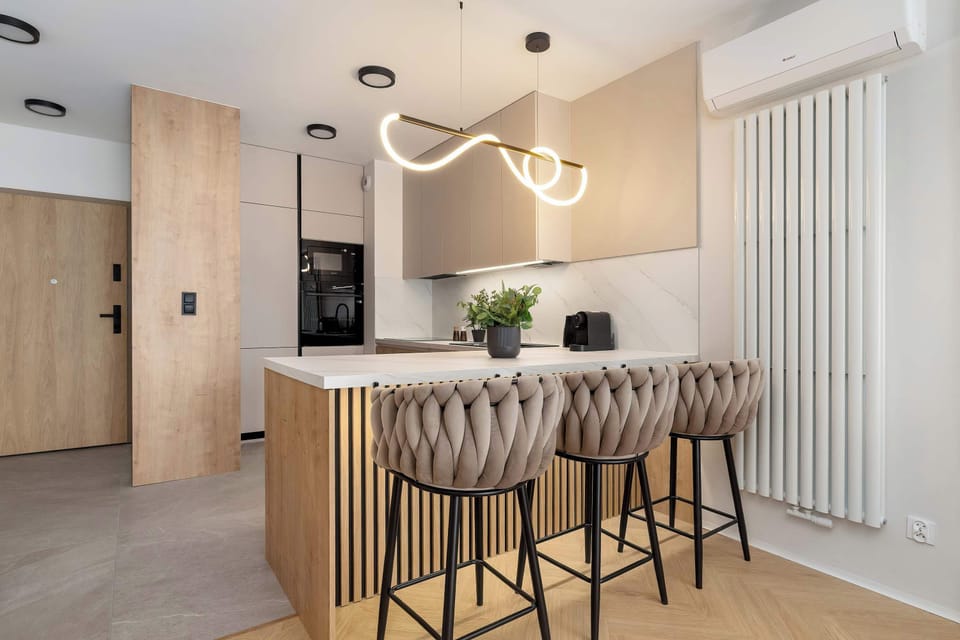Dining area with a large table and comfortable chairs, perfect for shared meals or remote work.