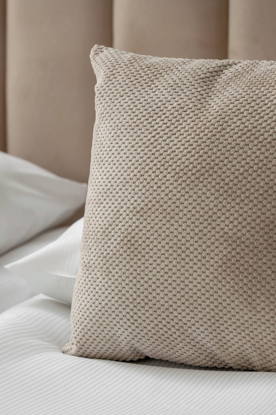 Bedroom detail showing soft textiles and attention to comfort.