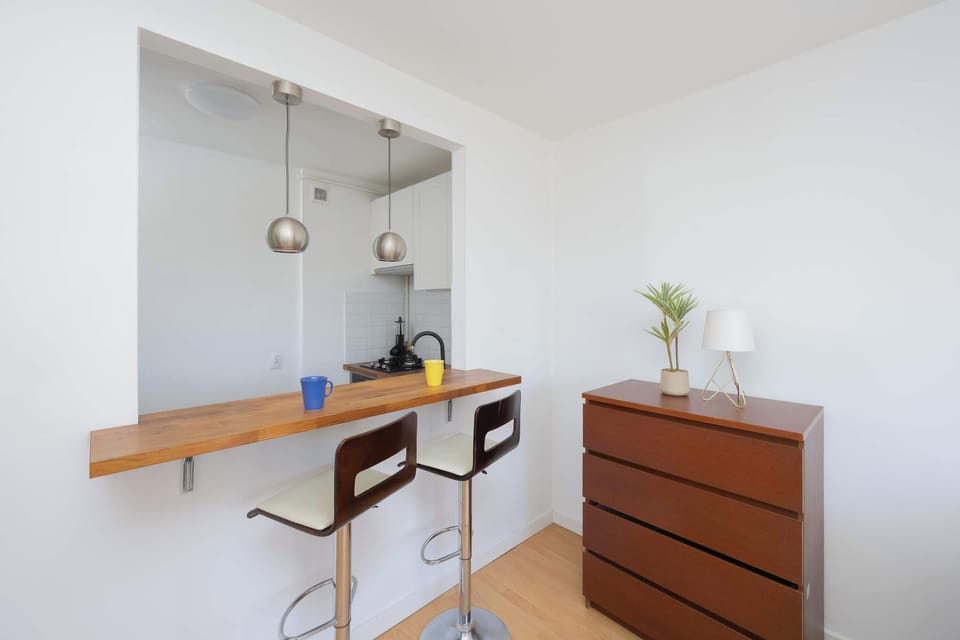 Dining area with countertop and bar stools.