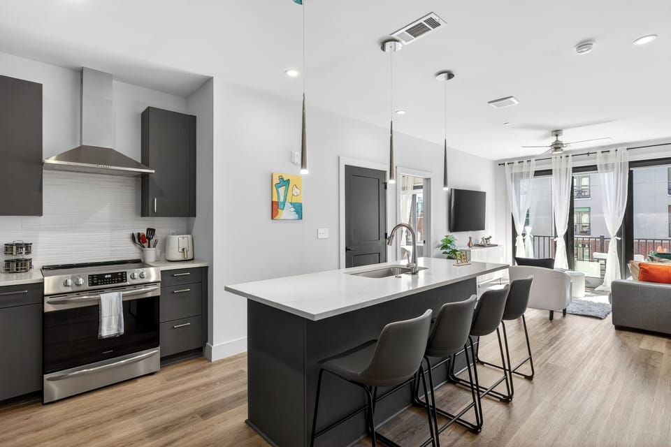 Open-concept kitchen + lounge with a spacious island for meals and mingling.
