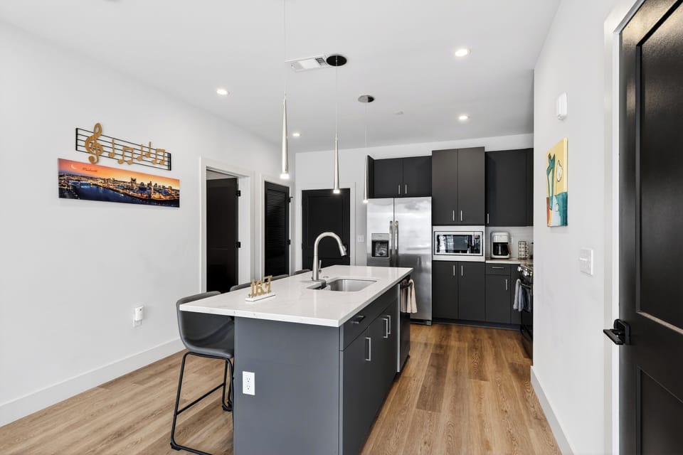 Sleek, modern kitchen with a spacious island—perfect for coffee, cocktails, and easy meals at home.