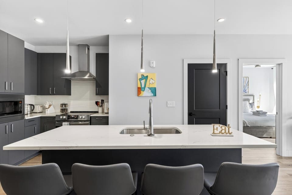 Sleek, modern kitchen with a spacious island—perfect for coffee, cocktails, and easy meals at home.