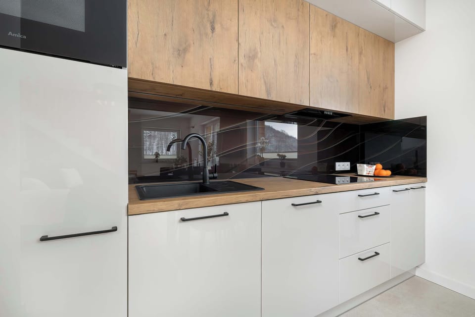 The kitchenette's modern design fits perfectly with the living area.