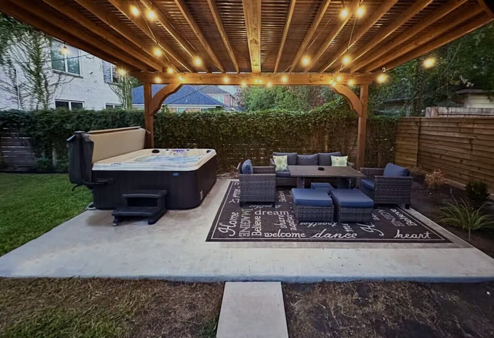 The outdoor lounge under the pergola — string lights, comfortable seating, and a peaceful space for the whole family to decompress after hospital visits.