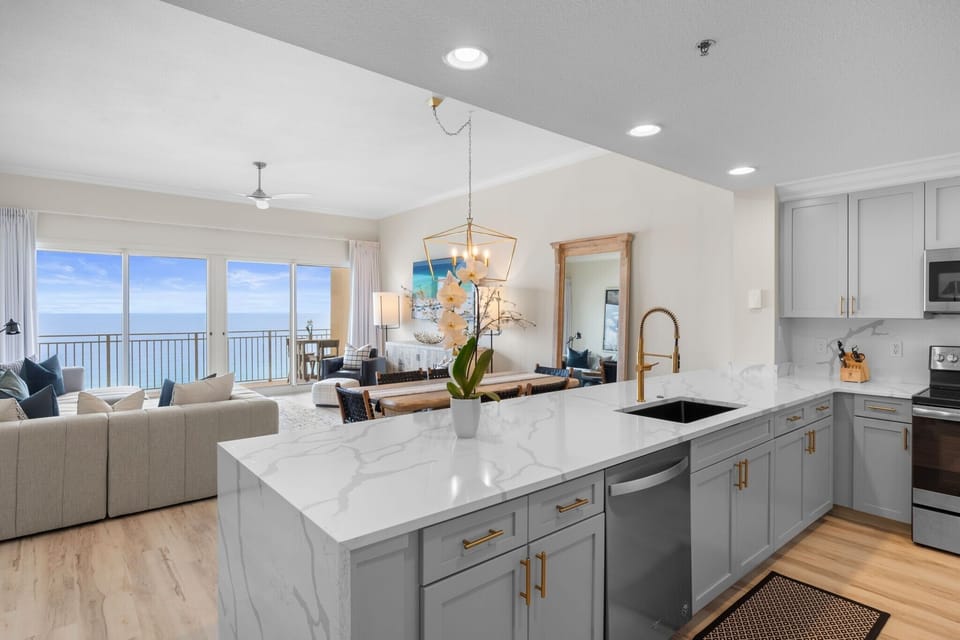 The fully equipped kitchen features quartz countertops, stainless-steel appliances, and has everything you need to prepare meals for family & friends.