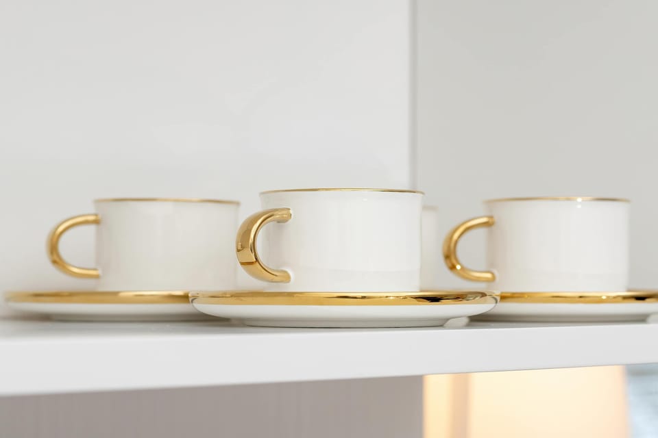 Elegant white cups displayed on shelving, highlighting thoughtful interior styling.