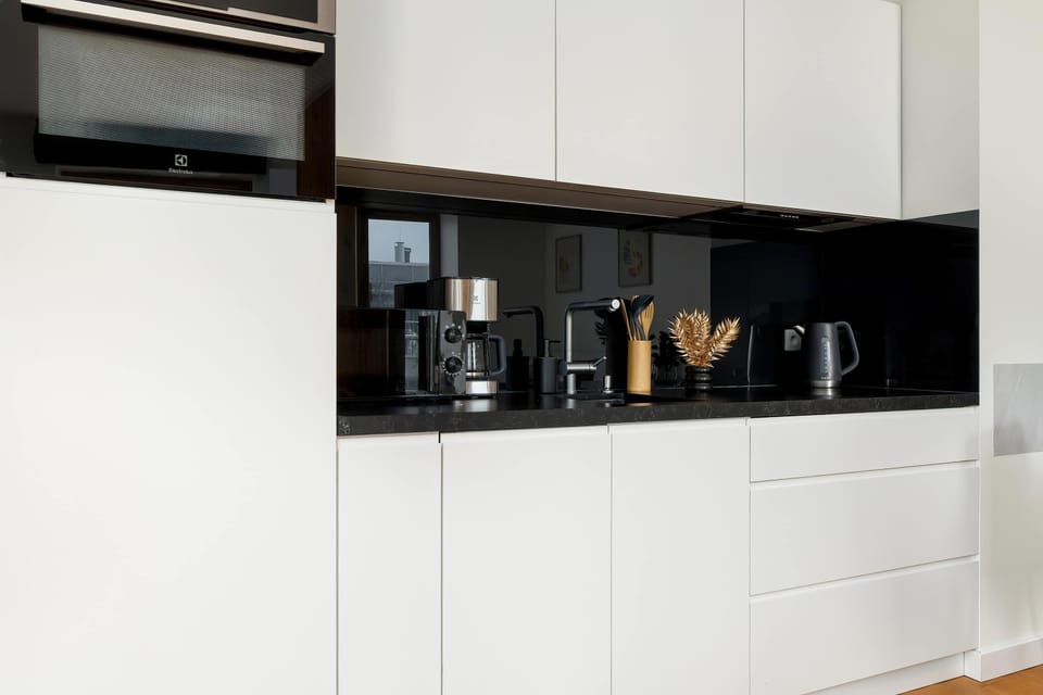The sleek design of the kitchenette blending seamlessly with the living area.