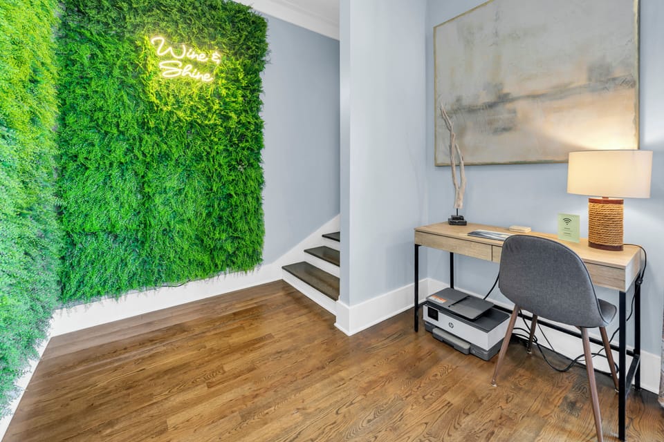 Your own productive workspace awaits with a stylish desk, cozy lighting, and an inspiring living moss wall that brings nature indoors.