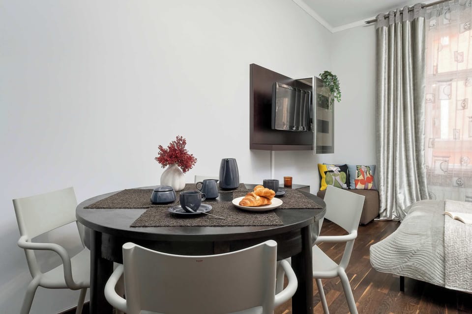 A compact dining space arranged within the studio near the bed. The setup shows how the apartment efficiently uses every part of the open area.