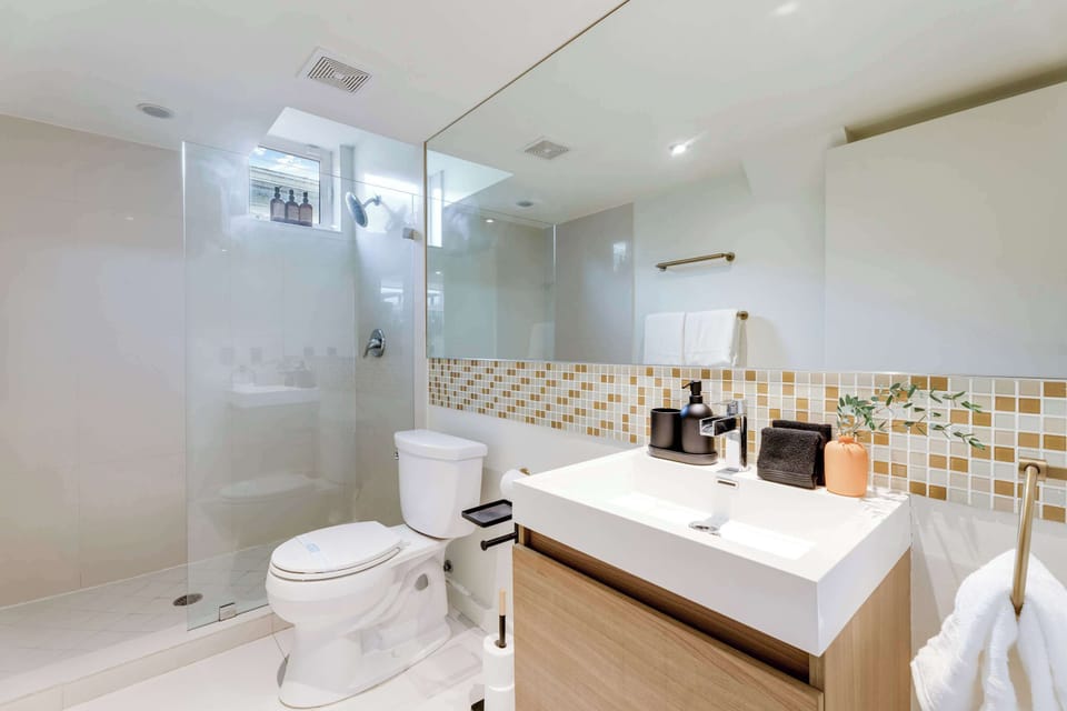 A stylish, functional bathroom featuring a large walk-in shower. Everything is ready for a comfortable stay.