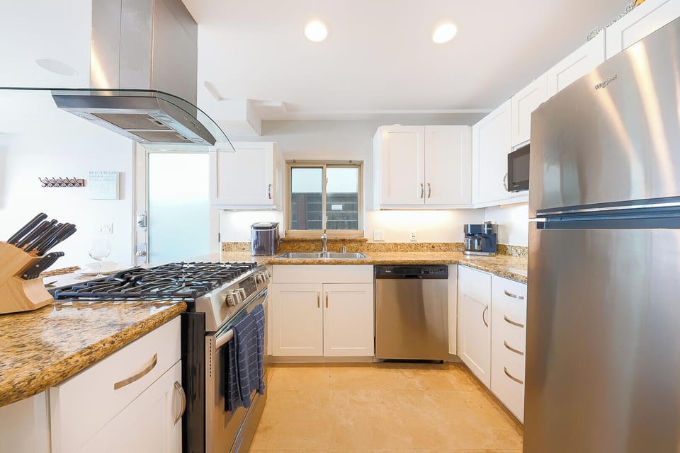  Contemporary kitchen featuring stainless steel appliances, designed for effortless cooking and a clean, modern look.