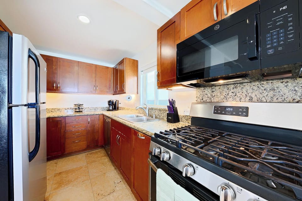 Modern kitchen equipped with cooking basics and appliances. 