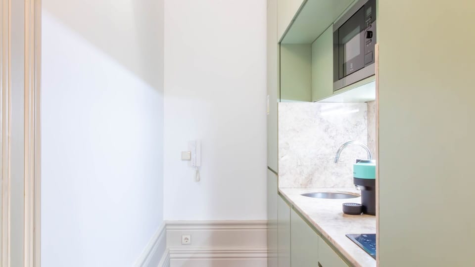 Compact kitchenette with sleek finishes. #CityLiving #SmartDesign