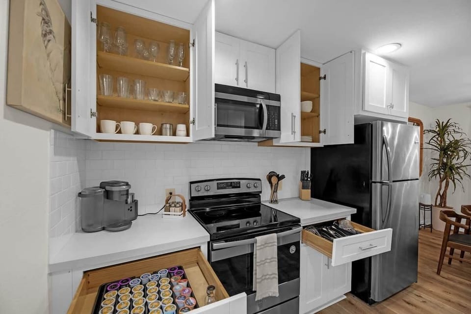 Start your day at the dedicated coffee station, stocked with a Keurig machine, coffee pods, mugs, and essentials for an easy morning routine. A cozy and convenient touch to make your mornings simple and relaxing.