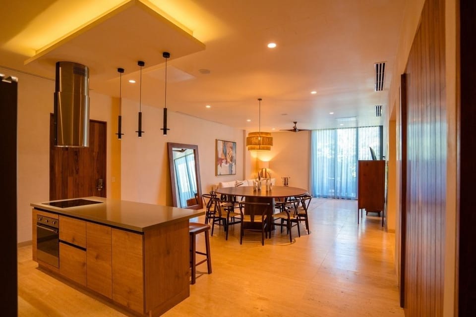 Unwind in the spacious open-plan lounge with soft, golden light.