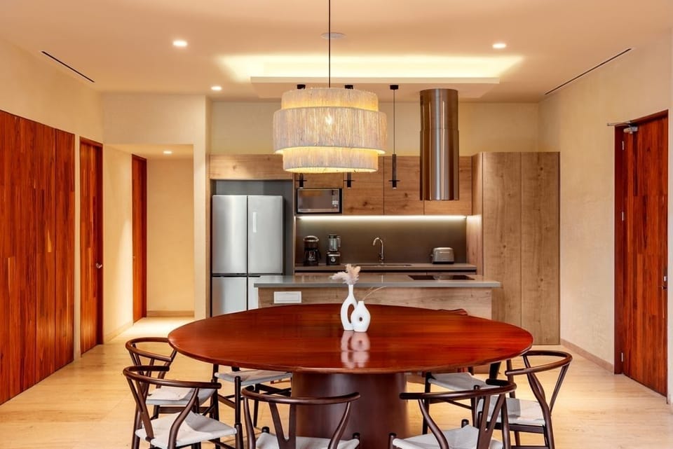 Gather for long dinners around the warm, designer dining table.