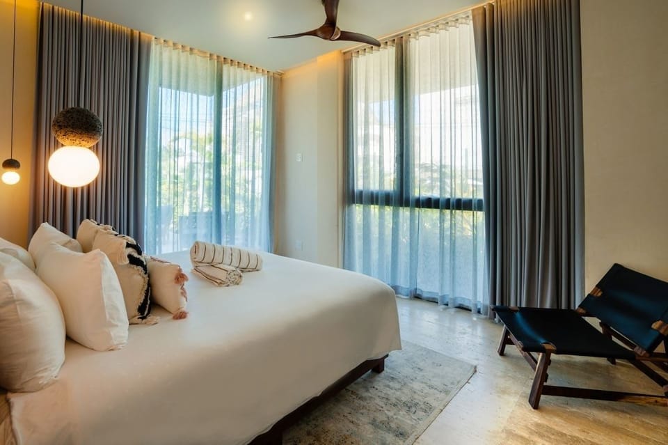 Wake up to soft daylight in a serene king bed.