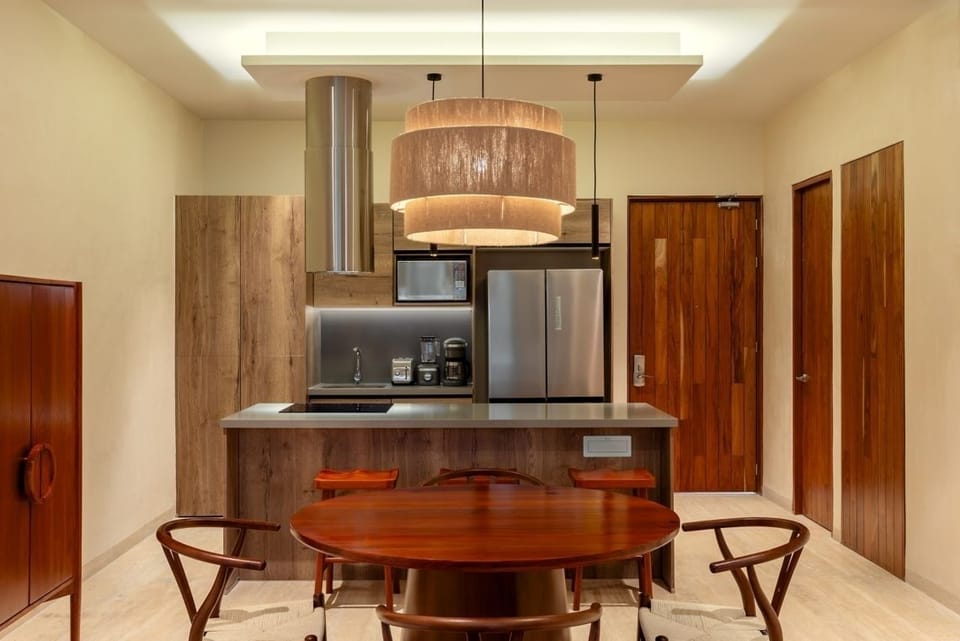 Cook and sip coffee in a sleek, modern kitchenette.