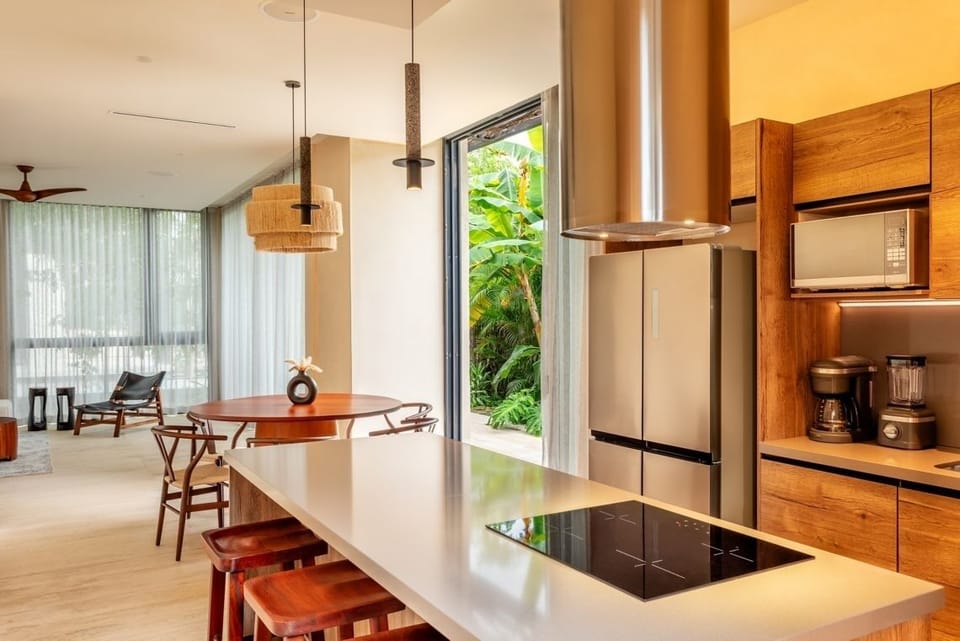 Cook with ease in a sleek kitchen opening to greenery.