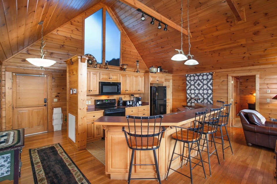 Prepare family meals in the fully equipped kitchen, featuring an open layout and breakfast bar.