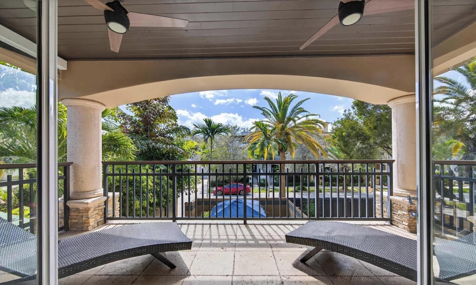 Primary Ensuite - Balcony w/ Lounge Chairs