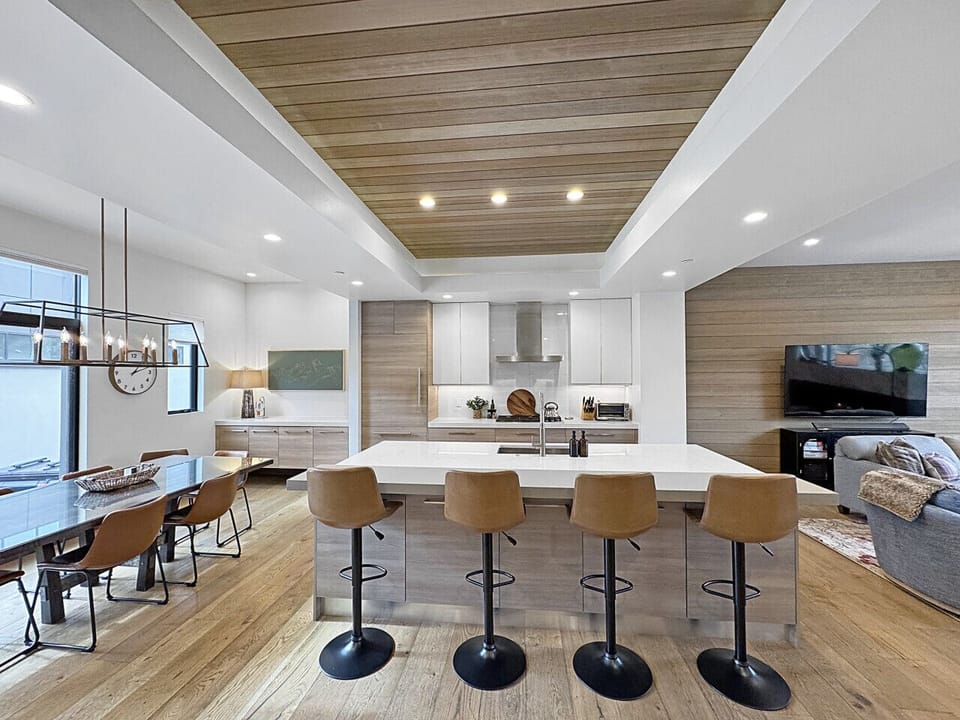 Three spaces, one breathtaking flow. Dine eight in natural light, cook in a stunning kitchen, unwind steps away. This is the heart of the home, and it shows