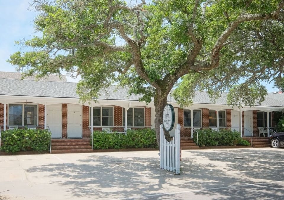 Quaint brick inn with shady porch, coastal charm, and easy parking
