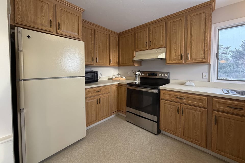 Fully stocked kitchen with fridge, microwave, stove and oven