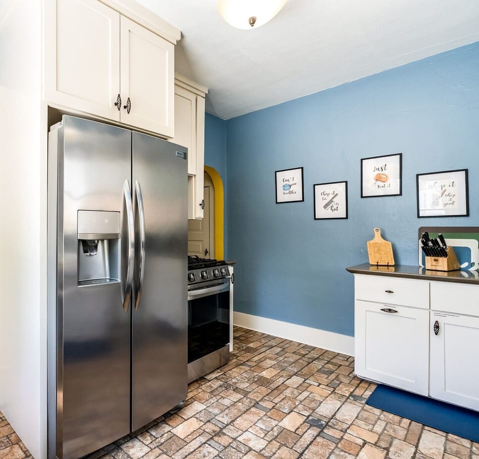 A true cook's kitchen featuring a premium gas range and ample stainless steel refrigeration. You'll find plenty of dishes, silverware, coffee cups, glasses, wine glasses and more for your group.