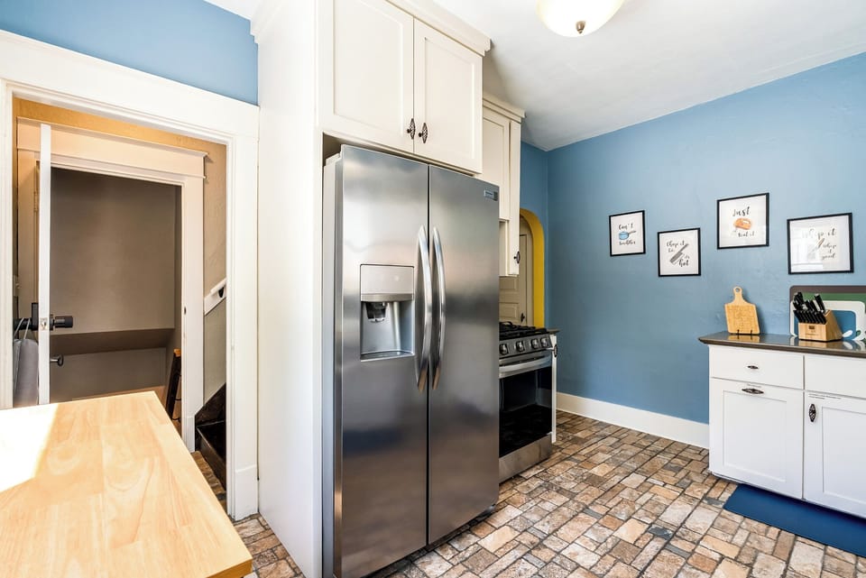 A true cook's kitchen featuring a premium gas range and ample stainless steel refrigeration. You'll find plenty of dishes, silverware, coffee cups, glasses, wine glasses and more for your group.