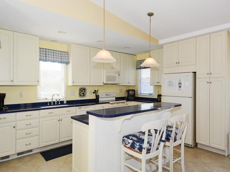 Inside, the bright and spacious kitchen features modern appliances and a comfortable breakfast bar, perfect for family gatherings.