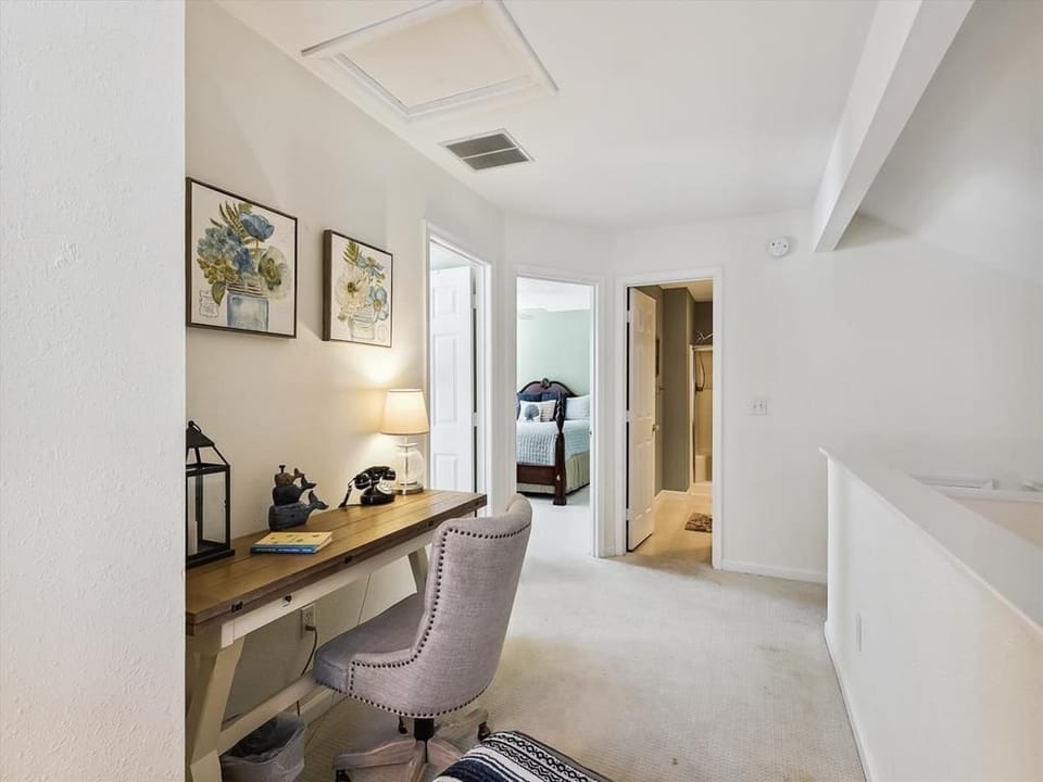 Quiet loft workspace offering a desk and cozy seating, perfect for catching up on emails during your coastal getaway.