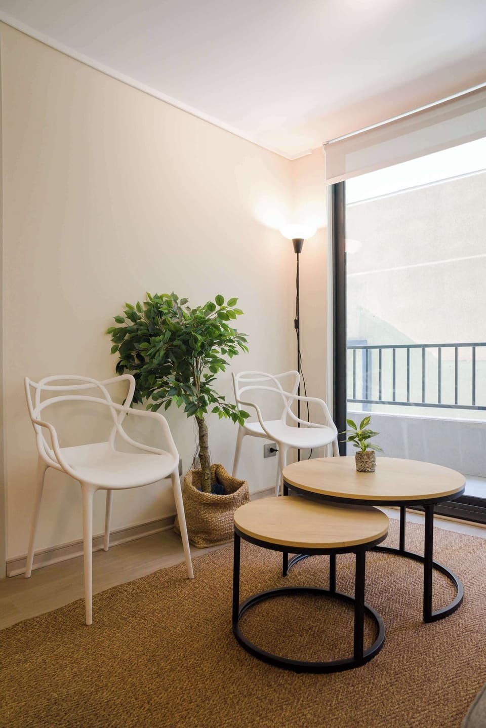 Relax in this cozy corner with stylish seating and a view of the balcony, perfect for unwinding after a day of exploring.