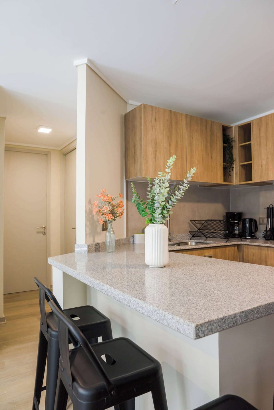 Sleek and modern kitchen with stylish bar seating, perfect for casual dining and entertaining.
