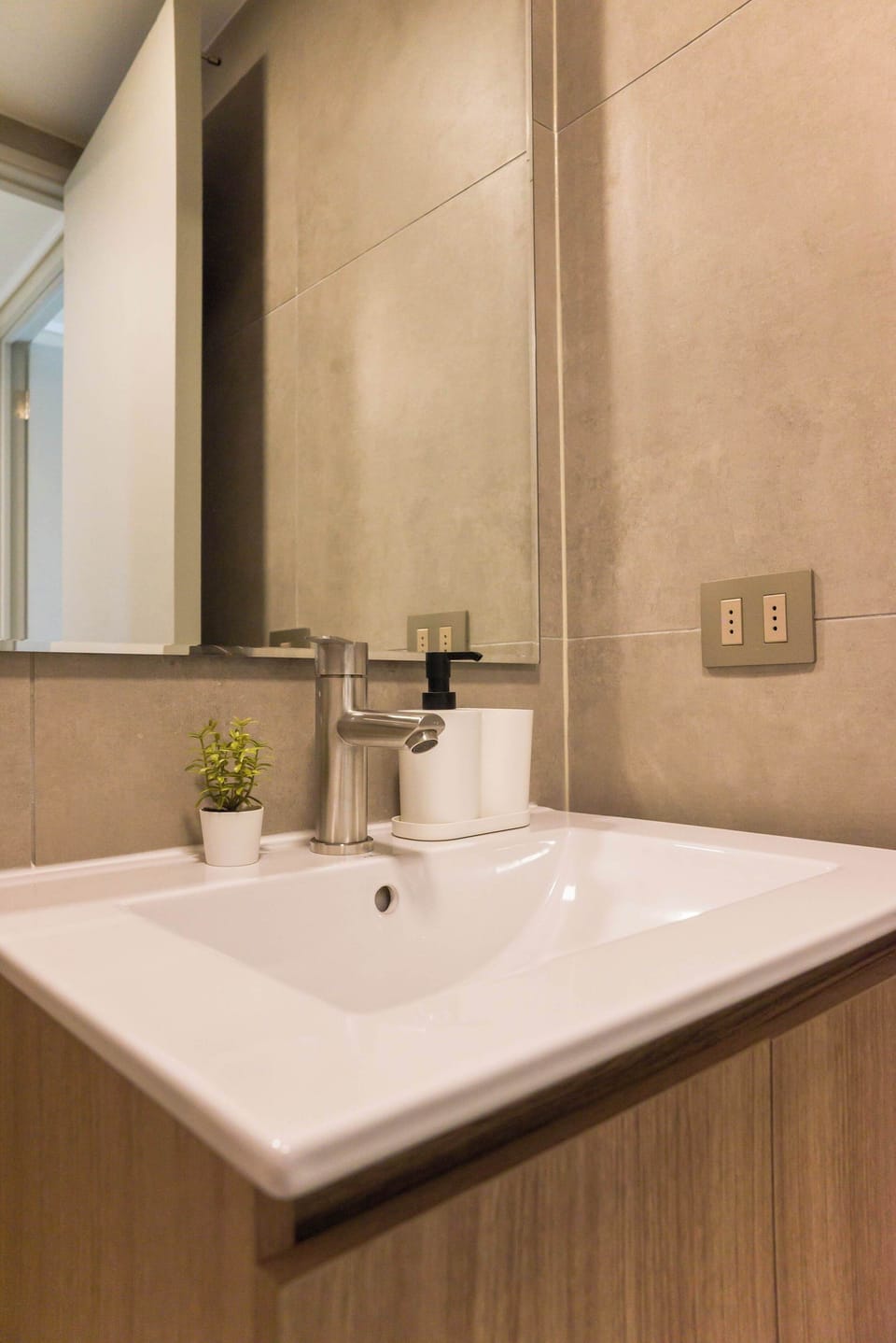 Experience modern elegance in this stylish bathroom, complete with a sleek sink and contemporary fixtures.