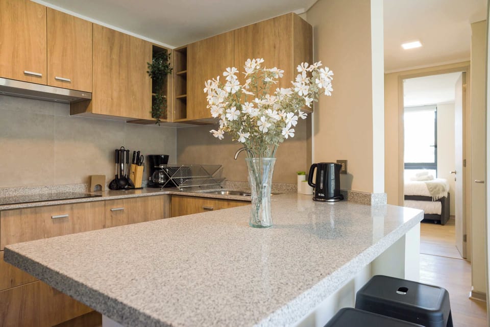 Stylish and modern kitchen with sleek countertops and cozy dining space, perfect for enjoying a homemade meal.