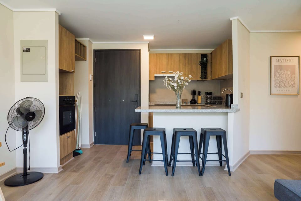 Stylish kitchen with modern amenities and cozy seating for four, perfect for enjoying meals and gatherings.
