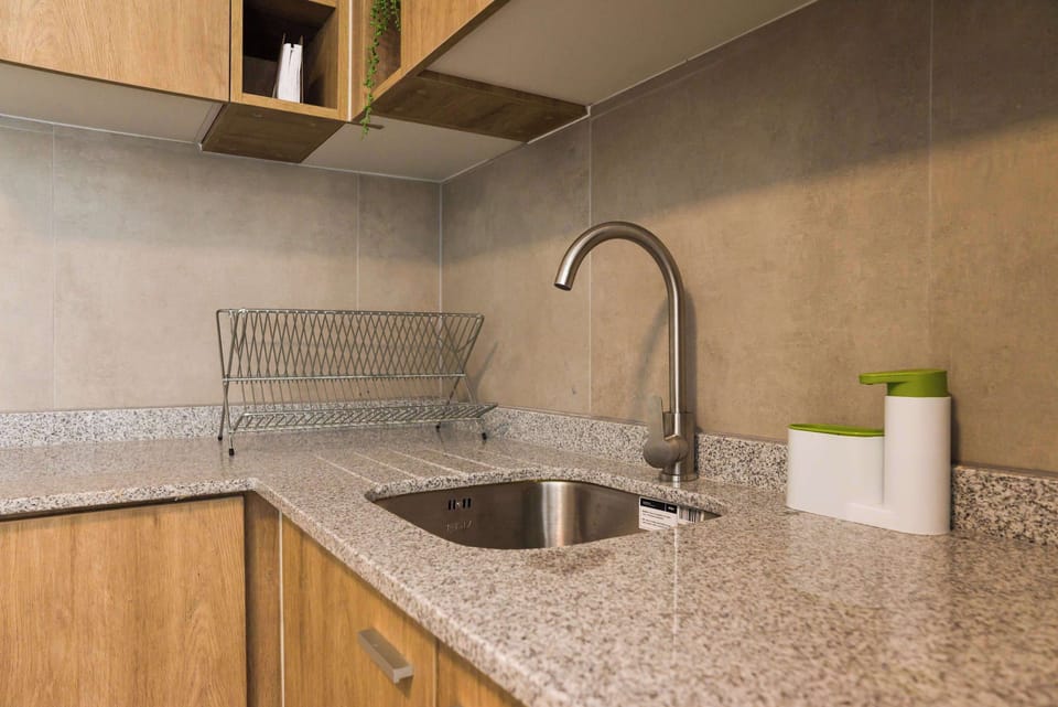 Modern kitchen with granite countertops and sleek fixtures, perfect for preparing meals.