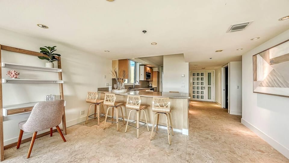 Bright, open kitchen and dining area with cozy workspace nook