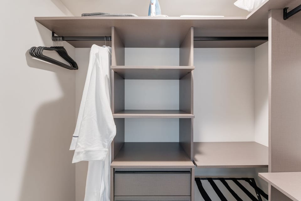 Spacious closet with shelving and hanging space for storage.