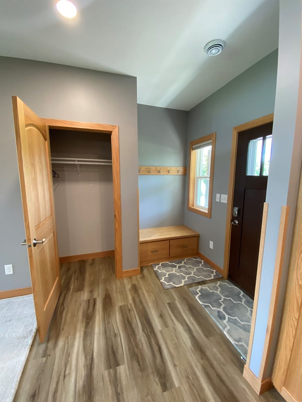 Front door area with nice sit down and closet space 