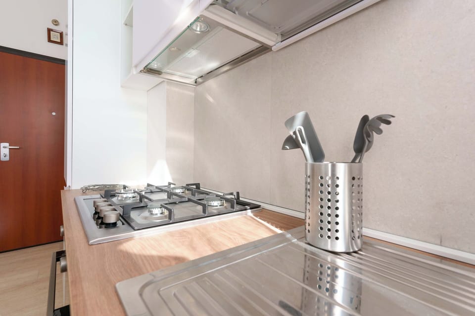 Apartment (Bilocale via cignani) | Private kitchen | Full-size fridge, oven, stovetop, dishwasher
