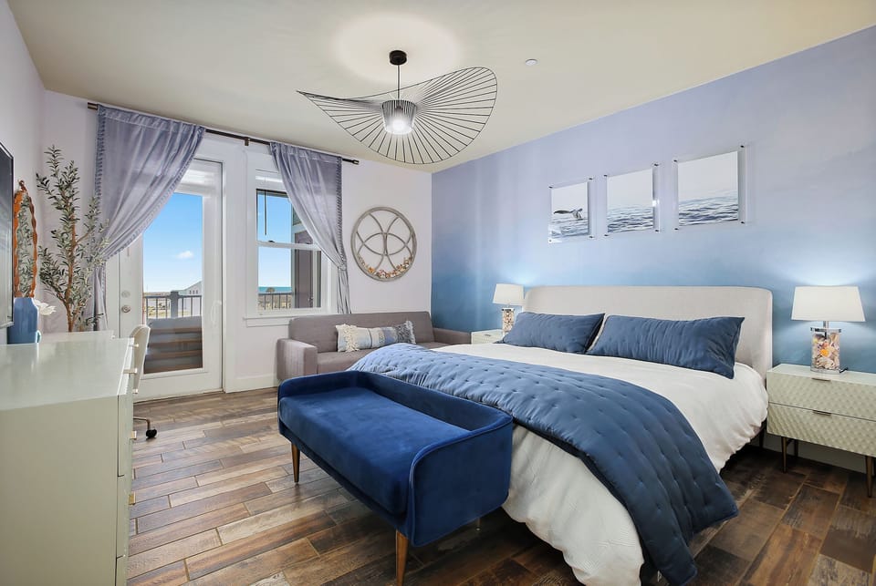 Master bedroom on the beach side with a king-size bed and a futon that can be us