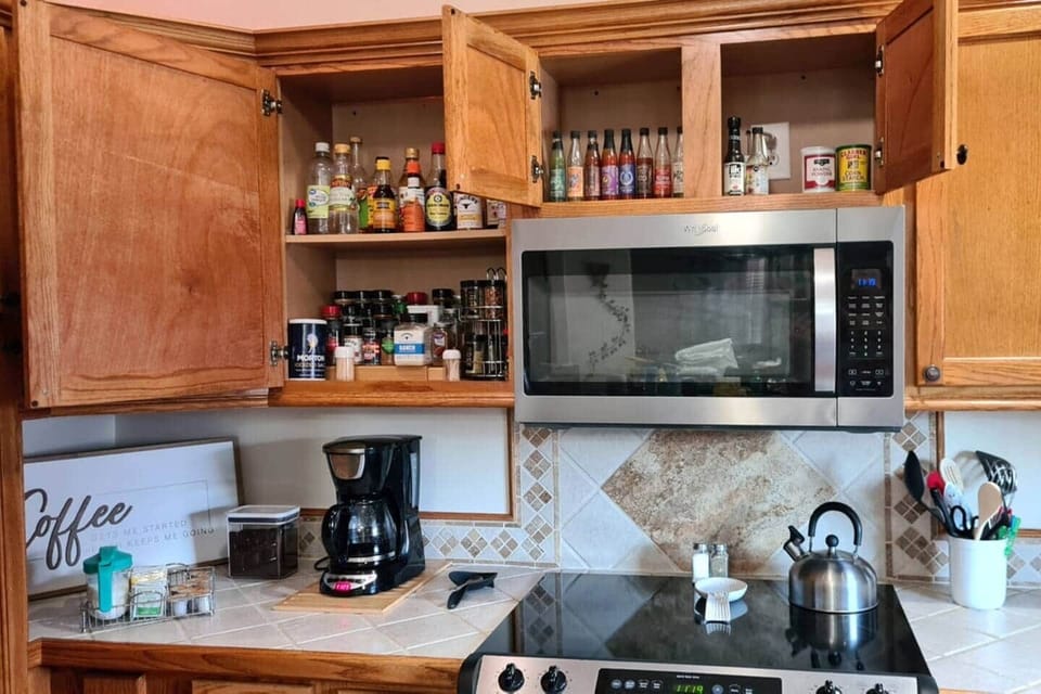 Furnished kitchen includes pans, mixing bowls, spices, blender, kettle, slow cooker + more