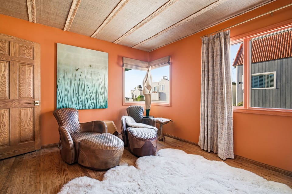 This sunlit sitting area blends warm tones and comfortable seating, creating a peaceful spot to pause and unwind.